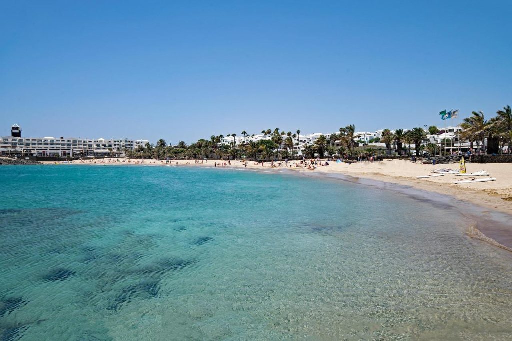 Home Zonnig Costa Teguise met uitgestrekte stranden, turquoise water en moderne hotels aan de Lanzarote kust
